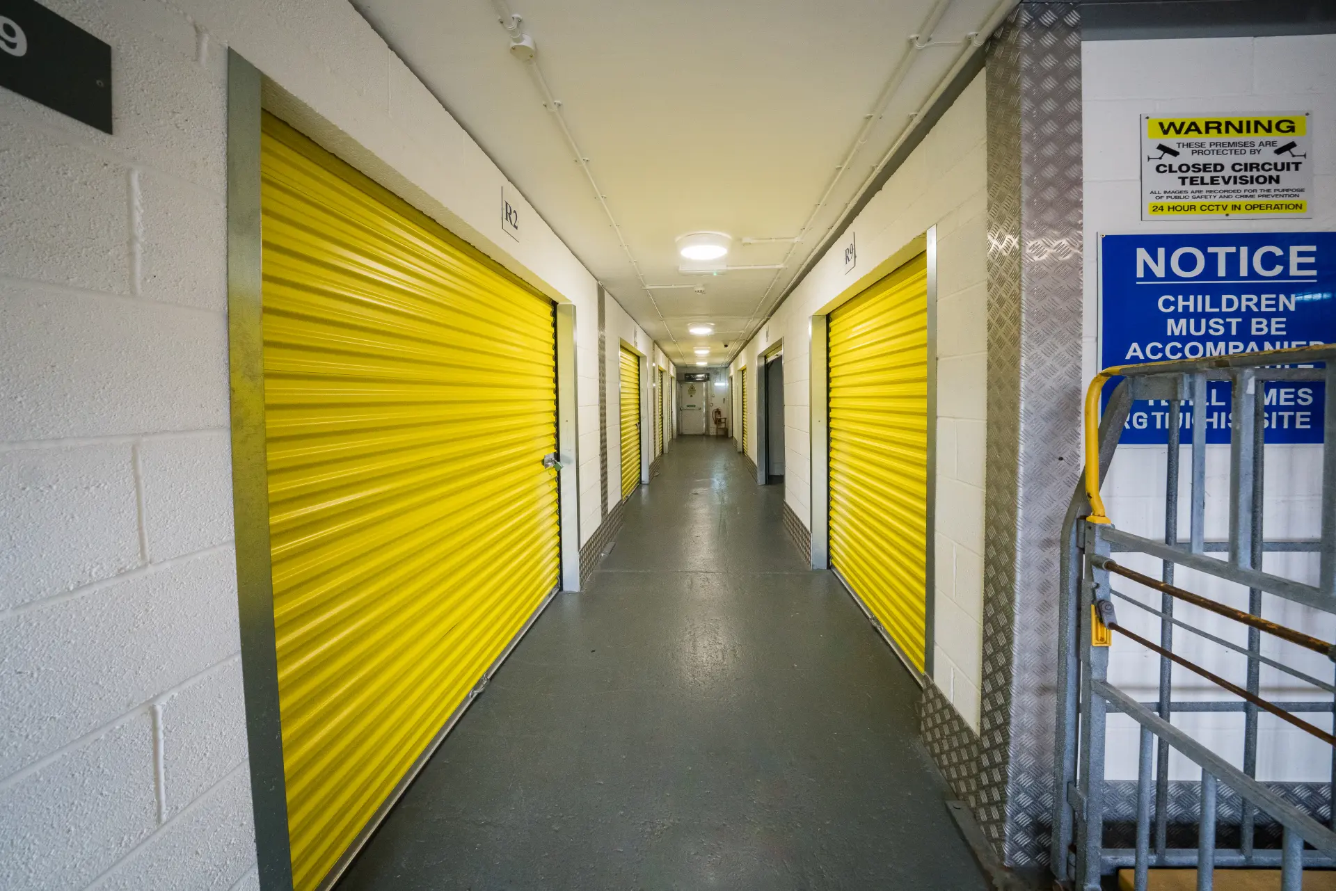 Atlantic Secure Self-Storage Barry Indoor Storage Corridor 1 Bright indoor corridor of Atlantic Secure Self-Storage with yellow roller-shutter doors on both sides